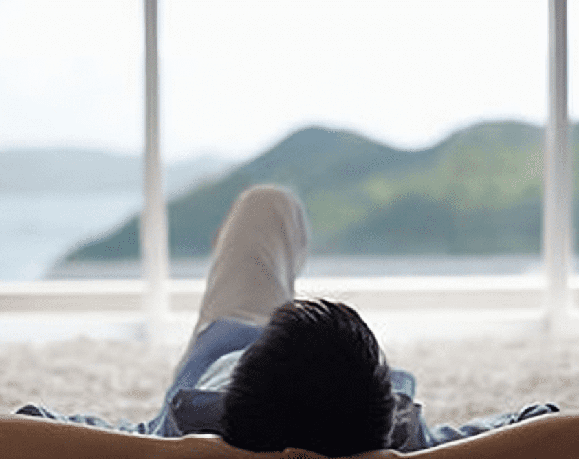 Person relaxing with scenic mountain view.